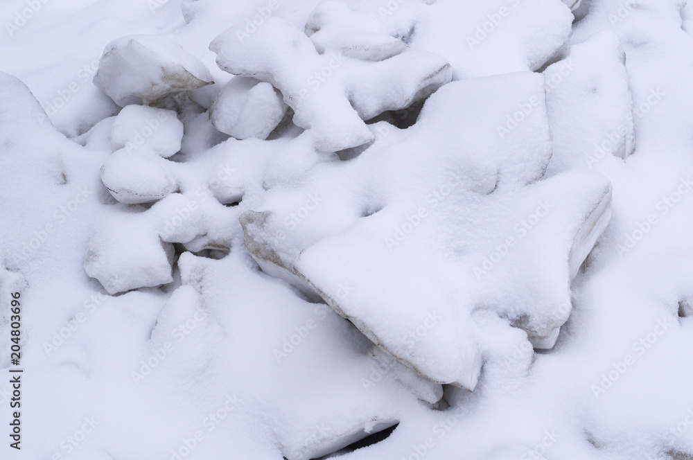 pile of melting ice blocks cowered with snow. seasonal, background, nature. pile of melting ice blocks cowered with snow. seasonal, background, nature.