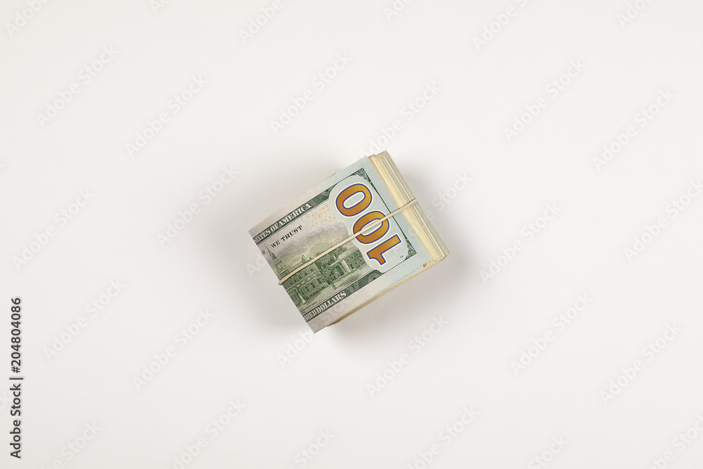 Stack of USA 100 dollars isolated on white background. Stack of USA 100 dollars isolated on white background.