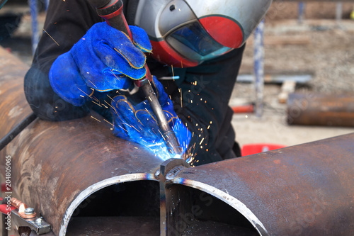 Worker welding in a factory. Welding on an industrial plant. photo