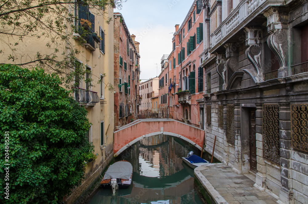 Venetian canal in the morning and view of the typical architecture with colorful houses, Italy