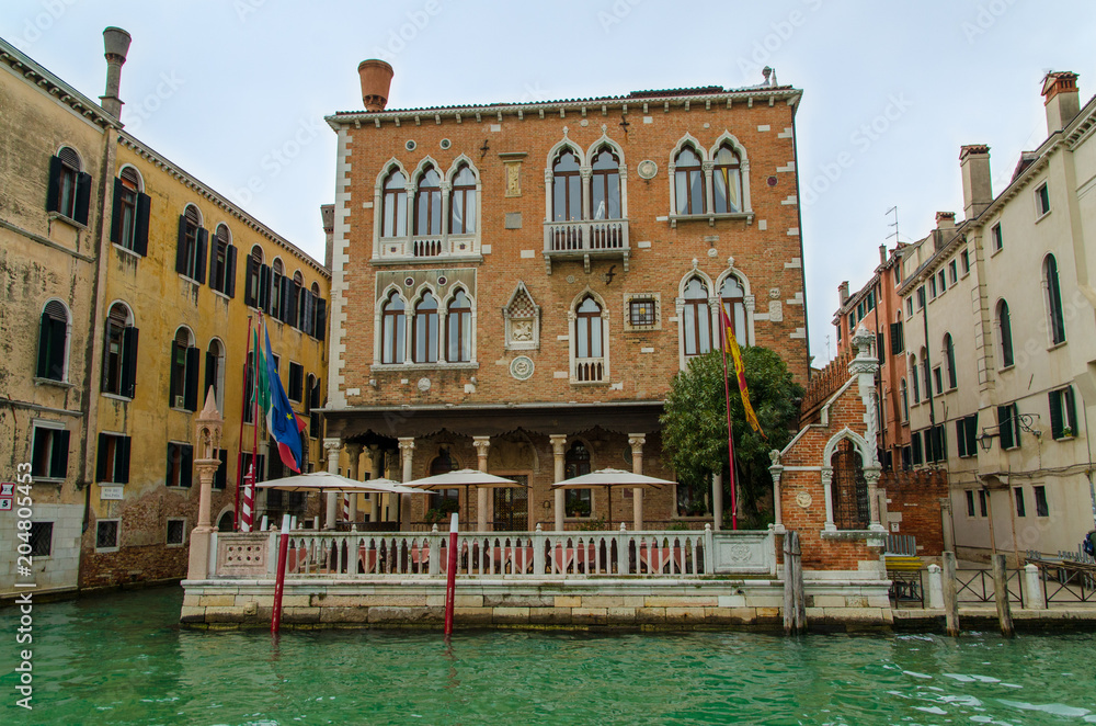 Typical house with terrace and pontoon on the Grand Canal in Venice, Italy