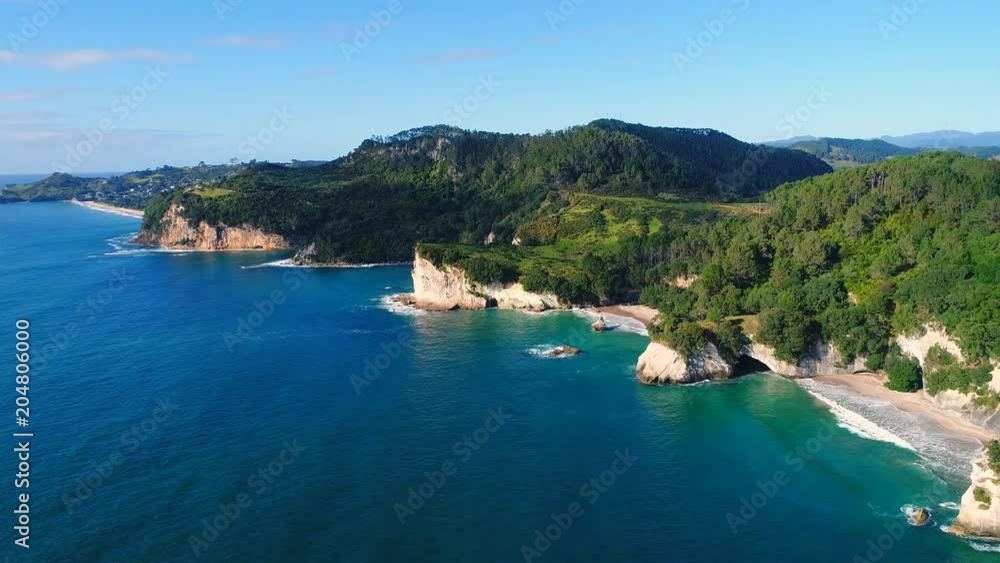 Aerial view of white cliffs and beaches of Cathedral Cove - South Pacific Ocean shore, Coromandel Peninsula, North Island, New Zealand from above, 4k UHD Aerial view of white cliffs and beaches of Cathedral Cove - South Pacific Ocean shore, Coromandel Peninsula, North Island, New Zealand from above, 4k UHD
