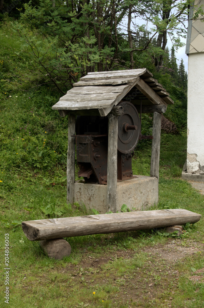Thingy; roofed machinery and rude bench in the Swiss woods Thingy; roofed machinery and rude bench in the Swiss woods