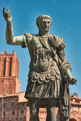 Rome, Bronze statue of emperor Caesar Nervae Trajan, Forum of Caesar Nervae Trajan in the background