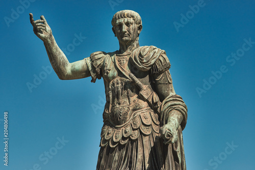 Rome, Bronze statue of emperor Caesar Nervae Trajan, Forum of Caesar Nervae Trajan in the background
