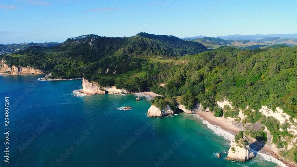Aerial view of white cliffs and beaches of Cathedral Cove - South Pacific Ocean shore, Coromandel Peninsula, North Island, New Zealand from above, 4k UHD Aerial view of white cliffs and beaches of Cathedral Cove - South Pacific Ocean shore, Coromandel Peninsula, North Island, New Zealand from above, 4k UHD