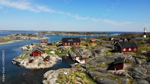 Aerial footage of red cabins on island 