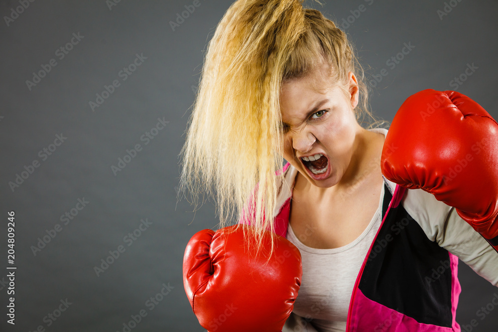 Angry woman wearing boxing gloves Angry woman wearing boxing gloves