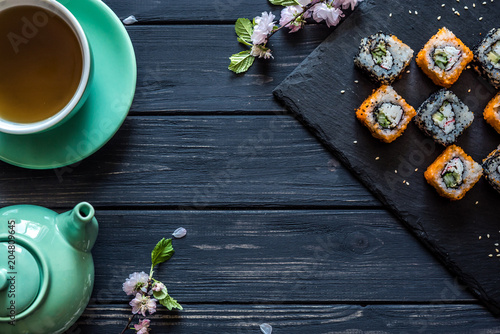 Sushi and tea in a kettle