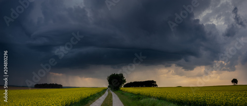 фотографія approaching storm over a country road