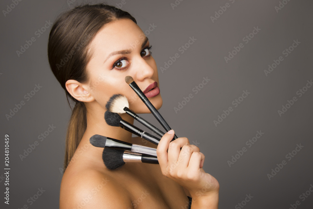 beautiful girl with make up brushes , perfect skin and make up woman concept beautiful girl with make up brushes , perfect skin and make up woman concept