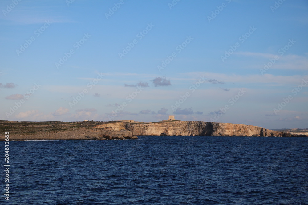 View to Comino island of Malta from Gozo, Mediterranean Sea