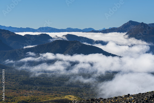 landscape from the heights of the Antillanca volcano, you can see the clouds of dawn entering through the valleys, south of Chile