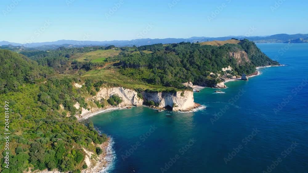 Aerial view of white cliffs and beaches of Cathedral Cove - South Pacific Ocean shore, Coromandel Peninsula, North Island, New Zealand from above, 4k UHD Aerial view of white cliffs and beaches of Cathedral Cove - South Pacific Ocean shore, Coromandel Peninsula, North Island, New Zealand from above, 4k UHD