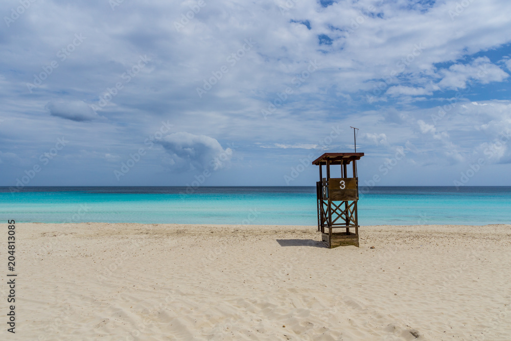 Mallorca, Lifeguard house on empty perfect white sand beach of paradise island Mallorca, Lifeguard house on empty perfect white sand beach of paradise island