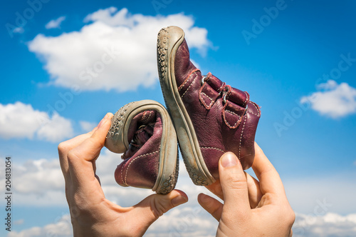 Obraz na płótnie Woman is holding barefoot shoes with flexible sole
