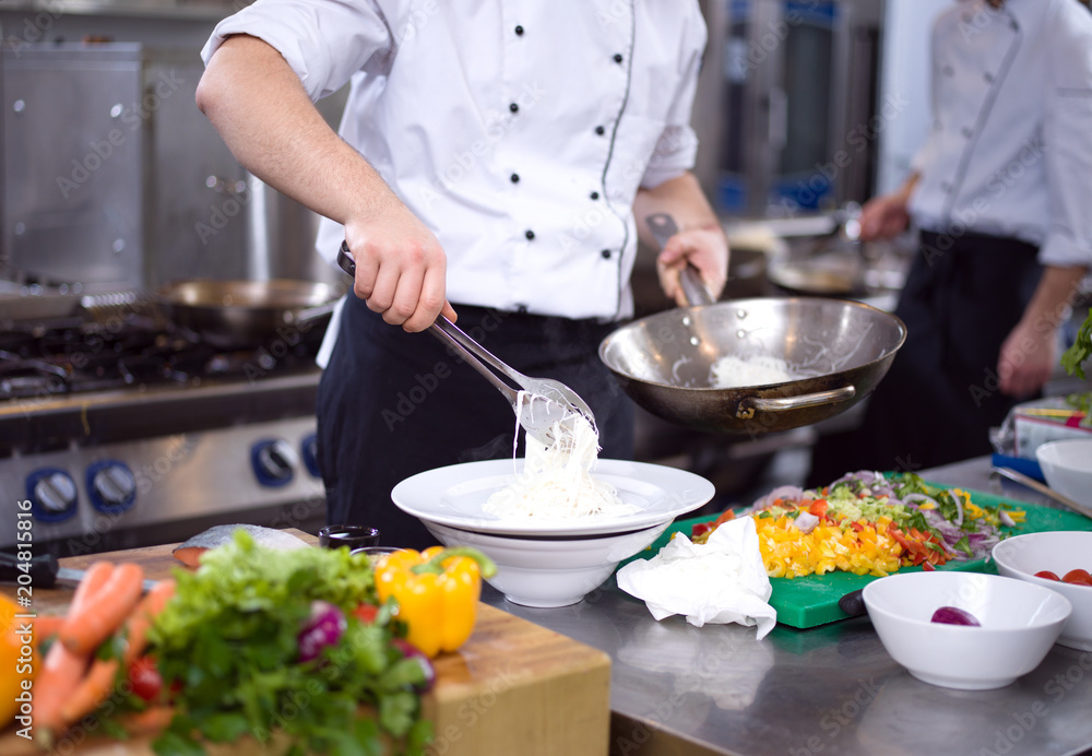 Chef hands serving spaghetti Chef hands serving spaghetti