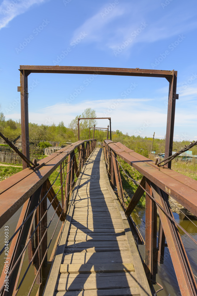 Old iron pedestrian bridge over the river Izhora. Old iron pedestrian bridge over the river Izhora.