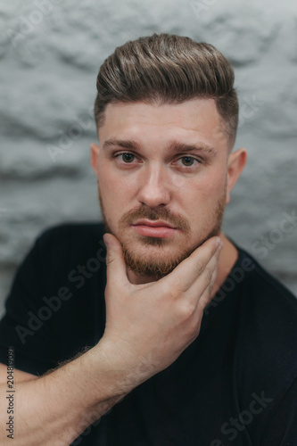 A man in a barber shop for haircuts and shaving