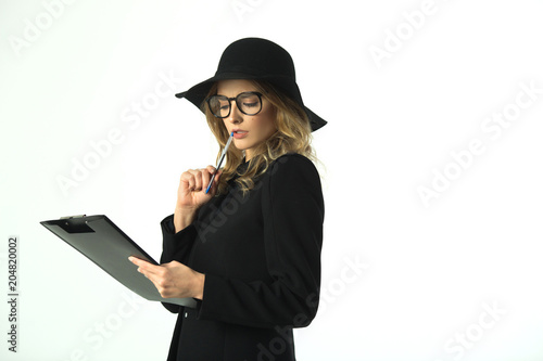 beautiful young girl in a hat on a white background with a folder of documents in hands