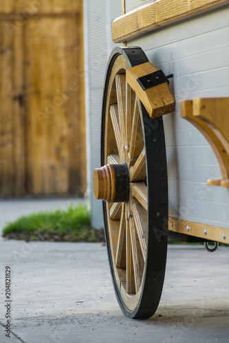 Old wooden wagon wheel. An old wooden wheel with wood spooks and hub used on a wagon or trailer