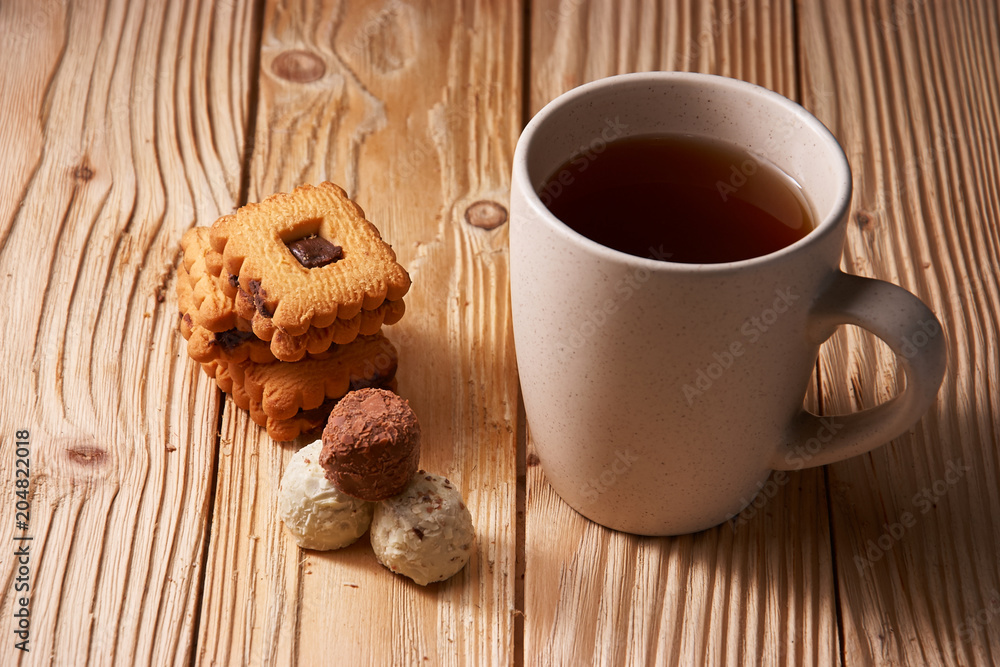 tee and cookies on a wooden table tee and cookies on a wooden table