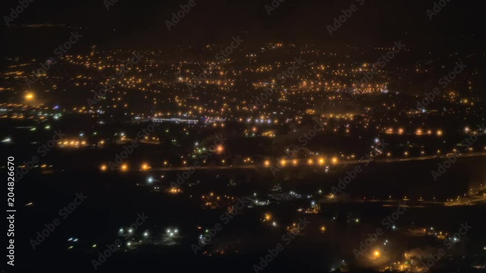 Aerial view of night Paris illuminated with thousands of lights in the darkness. View from flying airplane, France Aerial view of night Paris illuminated with thousands of lights in the darkness. View from flying airplane, France