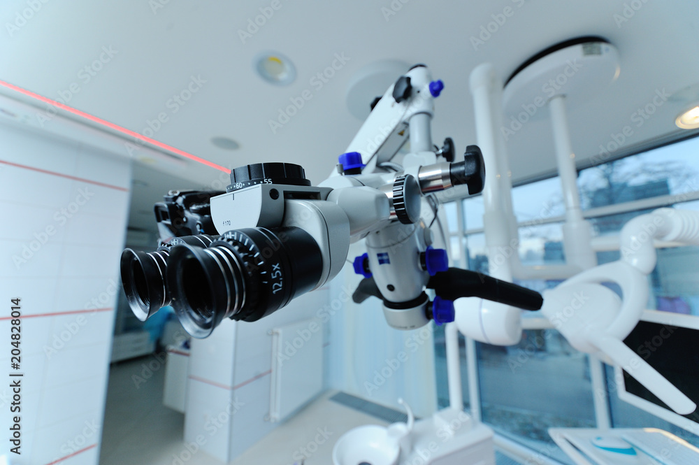 Dental microscope on the background of modern dentistry. Medical equipment Dental microscope on the background of modern dentistry. Medical equipment