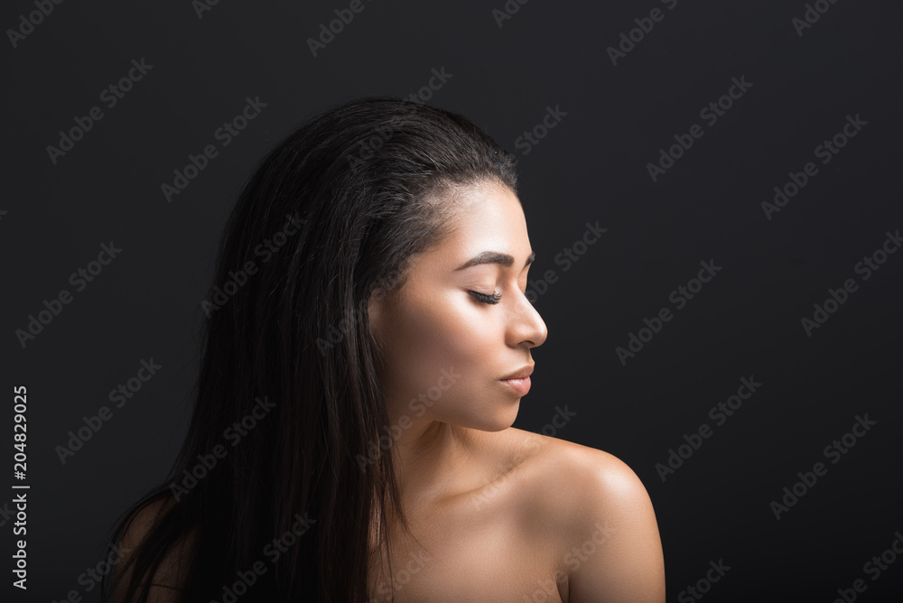 Profile of tranquil woman with closed eyes. Her hair is straightened and fresh. Isolated on black background Profile of tranquil woman with closed eyes. Her hair is straightened and fresh. Isolated on black background