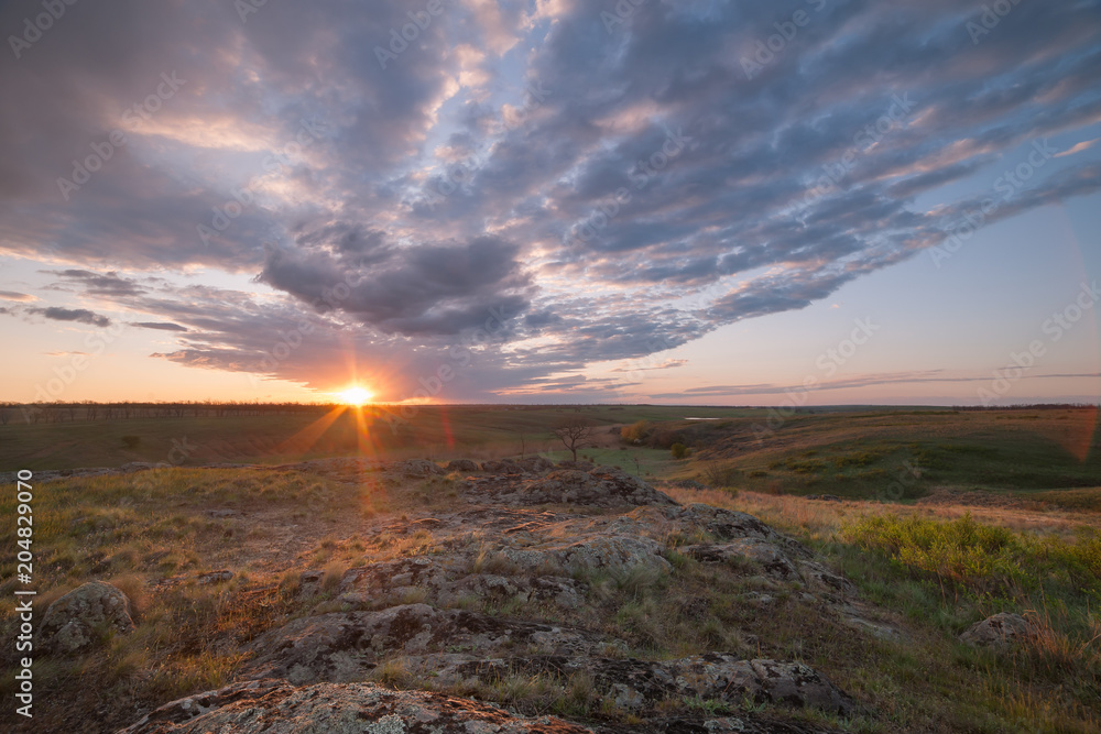 Fototapeta premium Sunrise over valley with clouds
