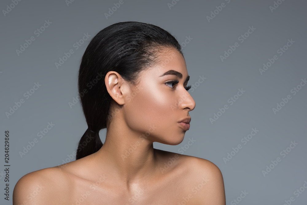 Purity concept. Calm woman demonstrating beautiful profile of her face. Isolated on background Purity concept. Calm woman demonstrating beautiful profile of her face. Isolated on background