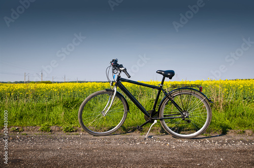 Black bike on a country road during spring