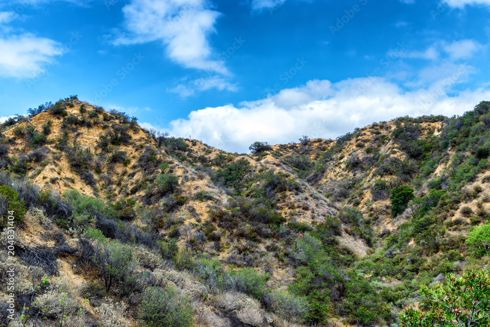 Dry hillsides and blue sky with room for copy text