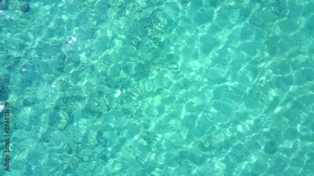 Aerial drone shot. A view of the corals from a bird's eye view. The camera looks down and slowly rises. Turquoise water of the Caribbean Sea. Riviera Maya Mexico. Aerial drone shot. A view of the corals from a bird's eye view. The camera looks down and slowly rises. Turquoise water of the Caribbean Sea. Riviera Maya Mexico.