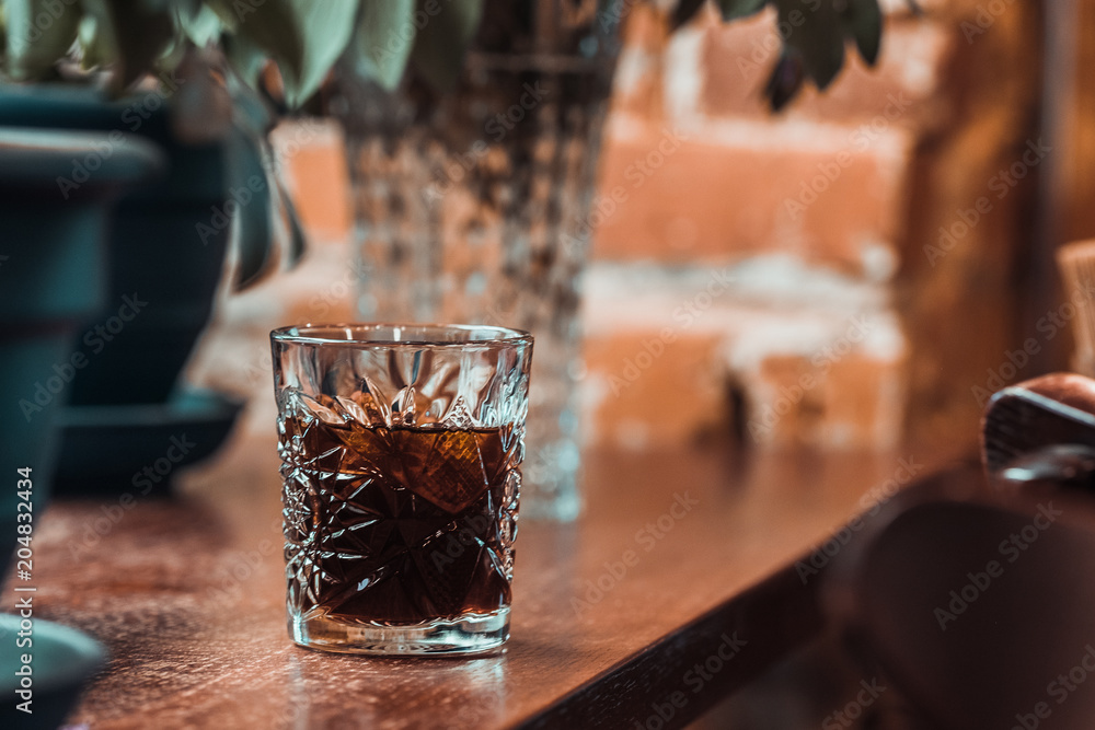 Black cold brew coffee with ice cubes in a glass at coffee shop. Drink photography