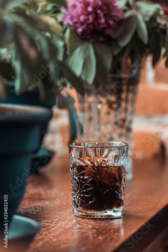 Black cold brew coffee with ice cubes in a glass at coffee shop. Drink photography