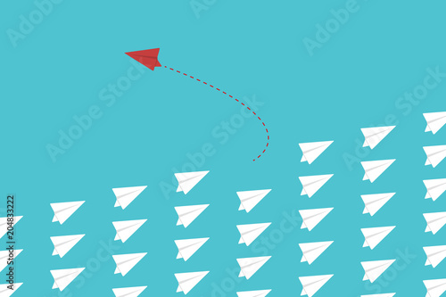 Think differently concept. Be different. Red airplane changing direction. New idea, change, trend, courage, creative solution, innovation and unique way concept.