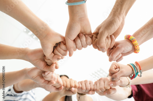 People putting hands togeth...