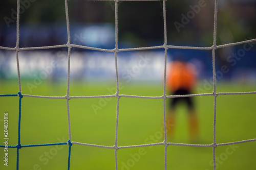 goalkeeper behind the net of the gate