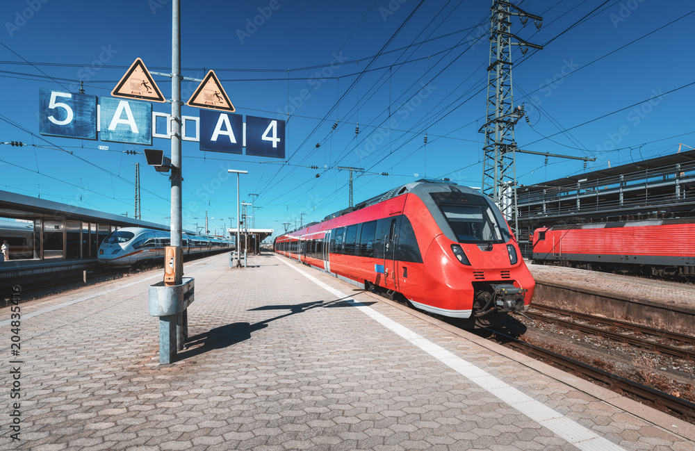 Red Intercity Train High speed red train on the railway station at sunset. Nuremberg ...