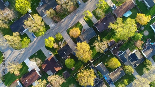 A stunning sight; Looking down on nice neighborhood with big trees blossoming in Springtime at first light of day.