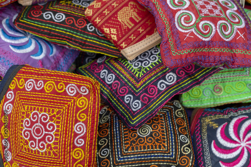 Cambodian traditional textile. Simple native ornament sewed on dark background. Colorful embroidery texture
