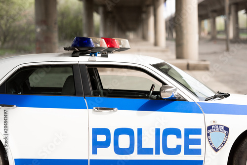 side view of empty police patrol car on street