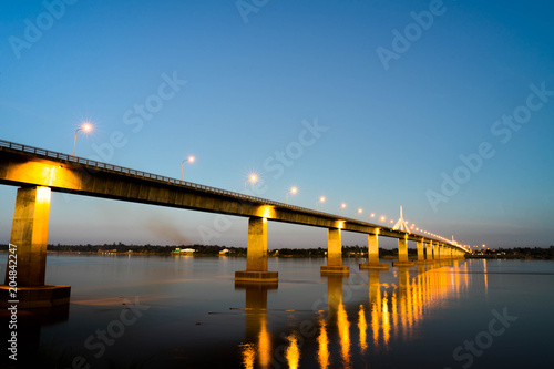 Bridge over the river in the morning, adorned with beautiful lights. © TEEREXZ