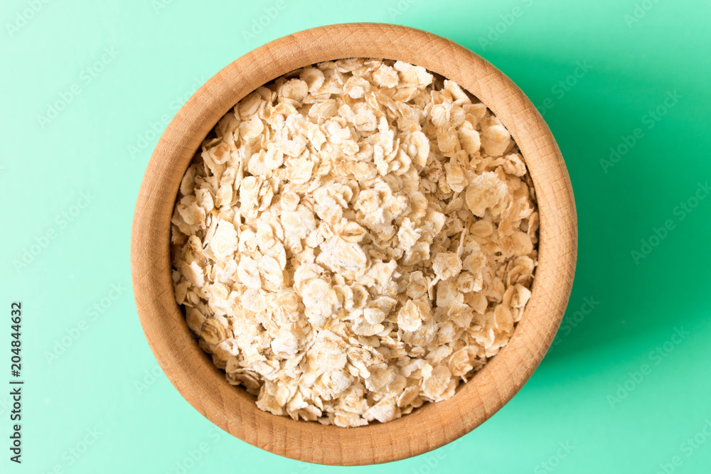 A bowl of cereal on a turquoise background. The concept of healthy food