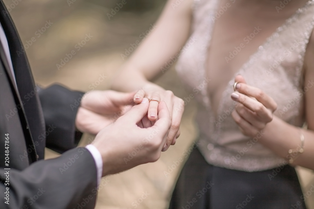symbol of the beginning of family life: the couple exchange wedding rings symbol of the beginning of family life: the couple exchange wedding rings