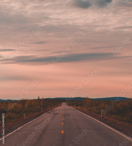 North Norway, evening with sunset on a long road near Kautokeino on a summer day