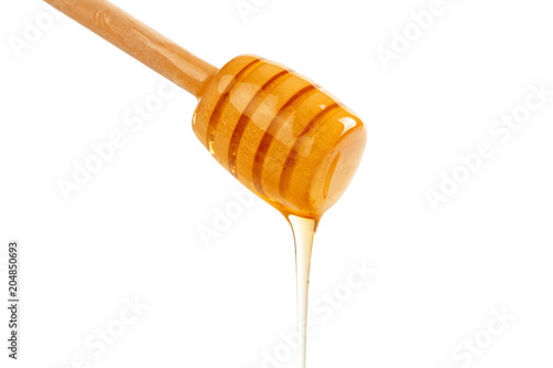 honey with wooden drizzler isolated on white background
