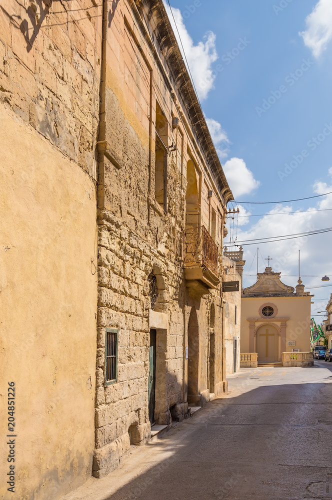Naxxar, Malta. The facade of the ancient building and the chapel of St. Lucy in the background