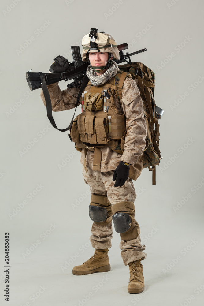 Soldier in camouflage holding rifle Soldier in camouflage holding rifle